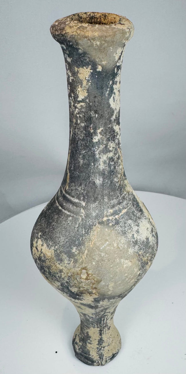 Side view of Iron Age grayware vessel showing tall neck and raised foot