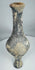 Side view of Iron Age grayware vessel showing tall neck and raised foot