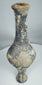 Side view of Iron Age grayware vessel showing tall neck and raised foot
