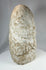 Ancient anthropomorphic stone carving with stylized proportions and aged texture