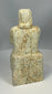 Carved stone worshipper figure with long robe and patina