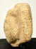 Side profile of ancient clay head highlighting skull curvature and facial relief