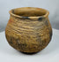 Hand-built Casas Grandes pottery jar dating to circa 1100–1450 CE, displaying traditional corrugated ceramic construction and warm buff coloration.