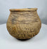 Historic Casas Grandes ceramic vessel from northern Mexico with wide mouth opening, corrugated shoulder bands, and mineral deposits.