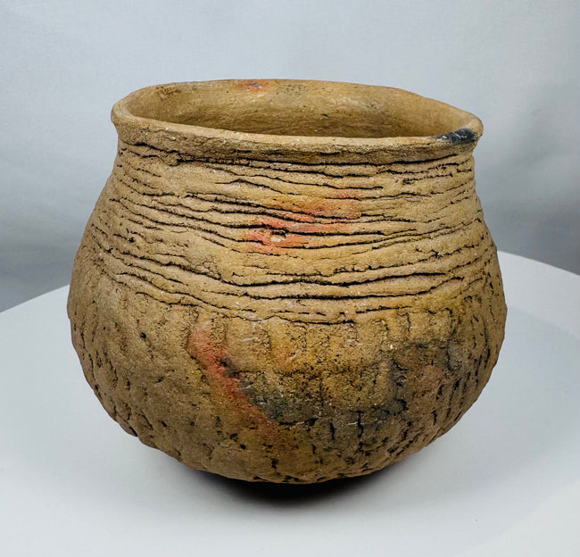 Pre-Columbian corrugated pottery jar attributed to the Casas Grandes culture, showcasing traditional utilitarian ceramic techniques and age-related wear.