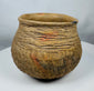 Pre-Columbian corrugated pottery jar attributed to the Casas Grandes culture, showcasing traditional utilitarian ceramic techniques and age-related wear.