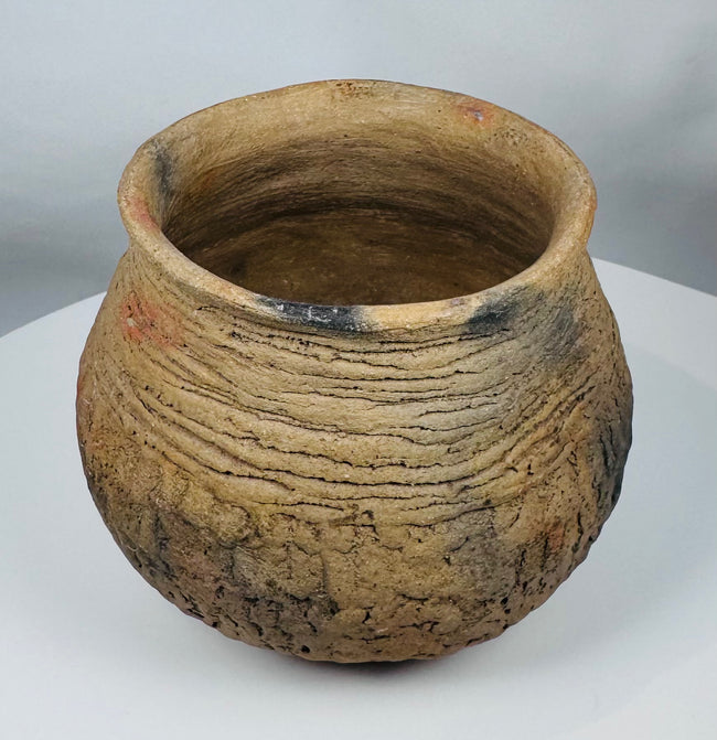 Pre-Columbian Paquimé corrugated plainware jar from the Chihuahua region of Mexico with visible firing marks and ancient craftsmanship.