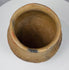 Ancient Casas Grandes storage vessel with rounded form, textured surface, and horizontal corrugated decoration around the upper body.