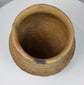 Ancient Casas Grandes storage vessel with rounded form, textured surface, and horizontal corrugated decoration around the upper body.