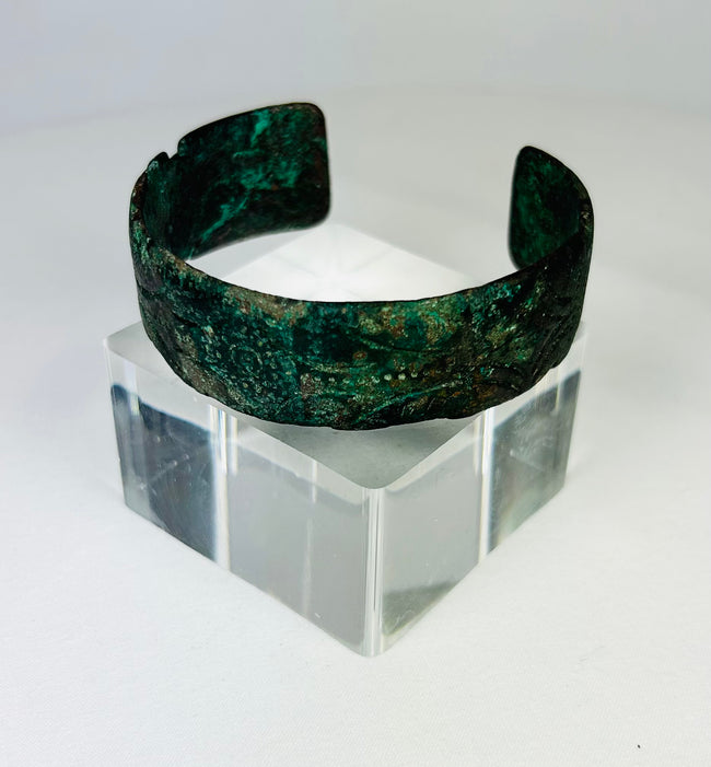 Detail view of incised decoration on ancient Persian bronze cuff bracelet