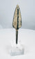 Ribbed lanceolate bronze projectile head with pale mineral encrustation