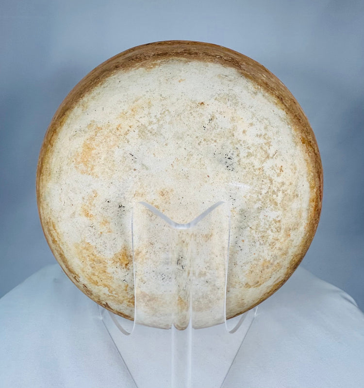 Ancient Mesoamerican terracotta bowl displaying firing variations and centuries-old burial patina.