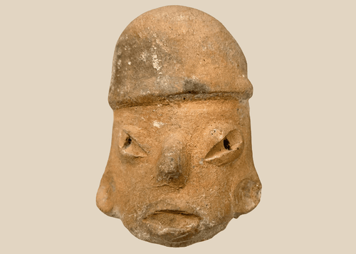 Pre-Columbian terracotta sculptural head with stylized facial features and hollow rear opening, Mesoamerica c.300 BCE–900 CE.