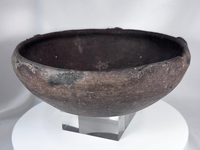 Pre-Columbian ceramic bowl with dark firing coloration and sculptural rounded profile
