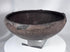 Pre-Columbian ceramic bowl with dark firing coloration and sculptural rounded profile