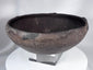 Pre-Columbian ceramic bowl with dark firing coloration and sculptural rounded profile
