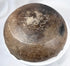 Ancient earthenware bowl with hemispherical body, fire-clouded finish, and aged patina