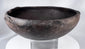 Hand-formed ancient pottery bowl with rim projections and mineralized archaeological surface