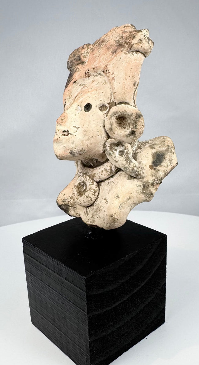 Mesoamerican figural fragment with elaborate regalia and archaeological mineral deposits