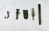 Assorted ancient Roman bronze artifact fragments including amulets, buttons, and decorative relics, 1st–12th century AD.