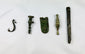 Assorted ancient Roman bronze artifact fragments including amulets, buttons, and decorative relics, 1st–12th century AD.