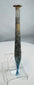 Ancient Roman pale blue glass candlestick unguentarium displaying archaeological weathering and iridescence