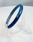 Complete Roman glass bracelet with rich blue coloration and evidence of long-term burial.