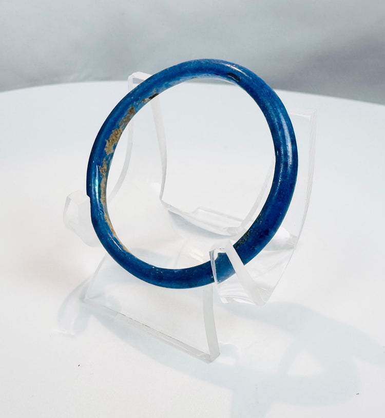 Authentic Roman blue glass bracelet featuring a complete circular form and smooth profile.