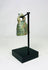 Full artifact photo of ancient Roman bell with looped handle and smooth rounded form.