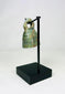 Full artifact photo of ancient Roman bell with looped handle and smooth rounded form.