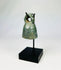 Close-up of Roman bronze bell showing textured green and brown patina from centuries of oxidation.