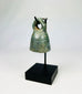 Close-up of Roman bronze bell showing textured green and brown patina from centuries of oxidation.