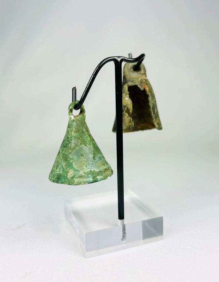 Early Roman bronze bell used for ritual or domestic protection, featuring centuries-old patina