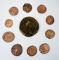 Ten Late Roman bronze coins arranged around a large central imperial coin, showing varied flan sizes, wear, and historic patination.