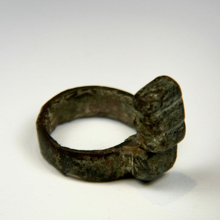 Ancient Roman ring key combining a circular bronze finger hoop with a functional locking mechanism