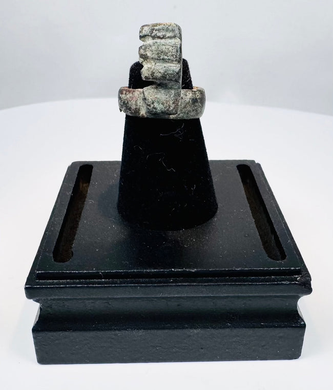 Ancient Roman ring key showing the weathered bronze surface and softened details produced by burial