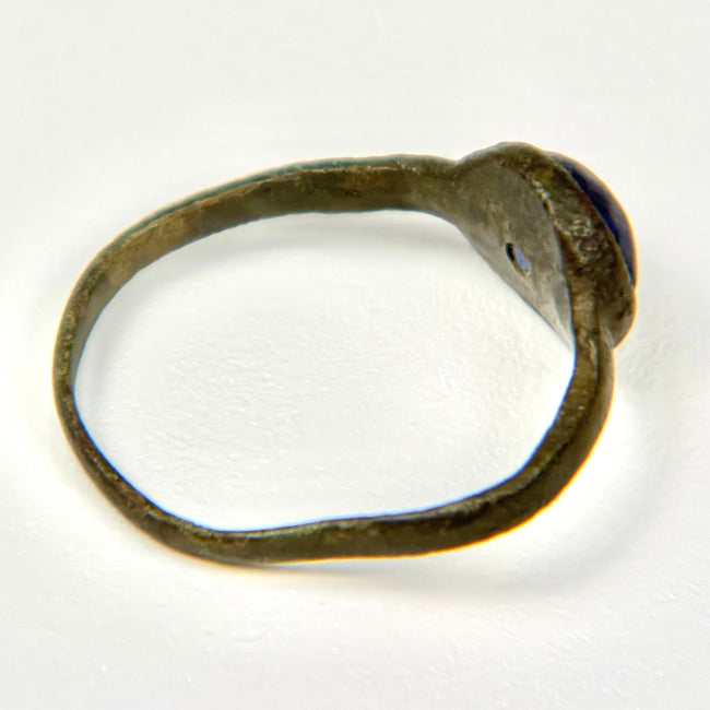 Close detail of blue glass cabochon mounted in an ancient bronze Roman ring bezel