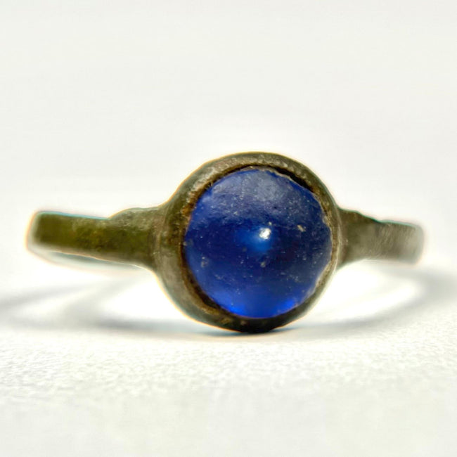 Close-up of Roman bronze ring with smooth round blue glass or glass-paste cabochon