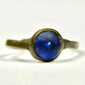 Close-up of Roman bronze ring with smooth round blue glass or glass-paste cabochon