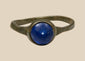 Ancient Roman bronze finger ring with round deep blue glass cabochon, circa 2nd–4th century CE