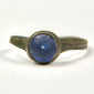 Front view of Roman bronze ring with domed cobalt blue glass stone in circular bezel