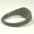 Profile view of ancient Roman bronze ring showing solid cast construction and thick expanding shoulders