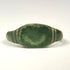 Roman Imperial bronze ring showing broad plain bezel and paired incised grooves along the shoulders