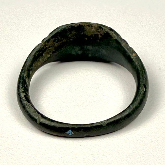Eastern Mediterranean Roman bronze finger ring with broad integral bezel and simple geometric shoulder decoration