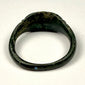 Eastern Mediterranean Roman bronze finger ring with broad integral bezel and simple geometric shoulder decoration