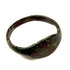 Side profile of ancient Roman bronze finger ring showing tapered shoulders and raised oval bezel