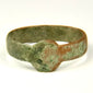 Roman Imperial bronze ring showing extensive green archaeological patina and reddish-brown bronze surface