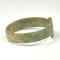 Side view of Roman bronze ring showing widened shoulders and projecting rounded bezel