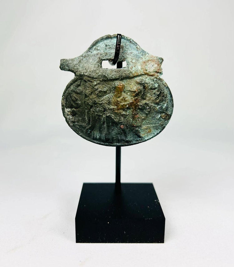 Ancient Roman bronze pendant with engraved soldier figures from the 1st–4th century CE.