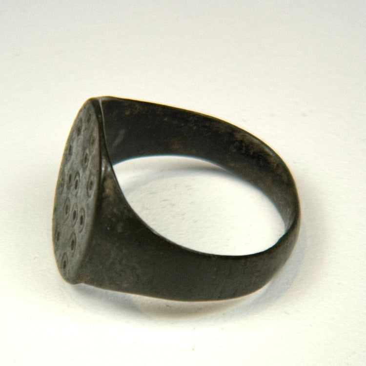 Roman period bronze ring with preserved engraved dot-and-circle motifs and rich archaeological patina